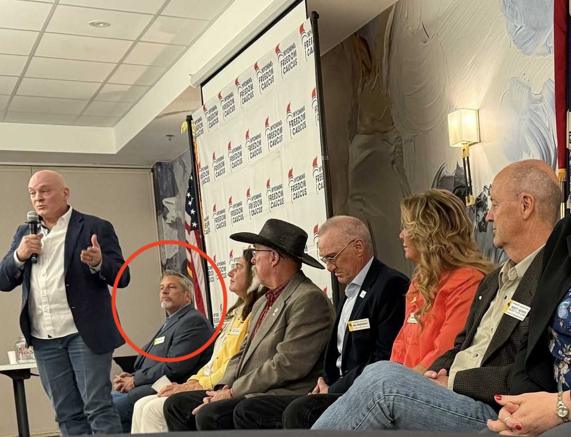 Rep. Locke (seated, left) on stage at a Casper Freedom Caucus event.